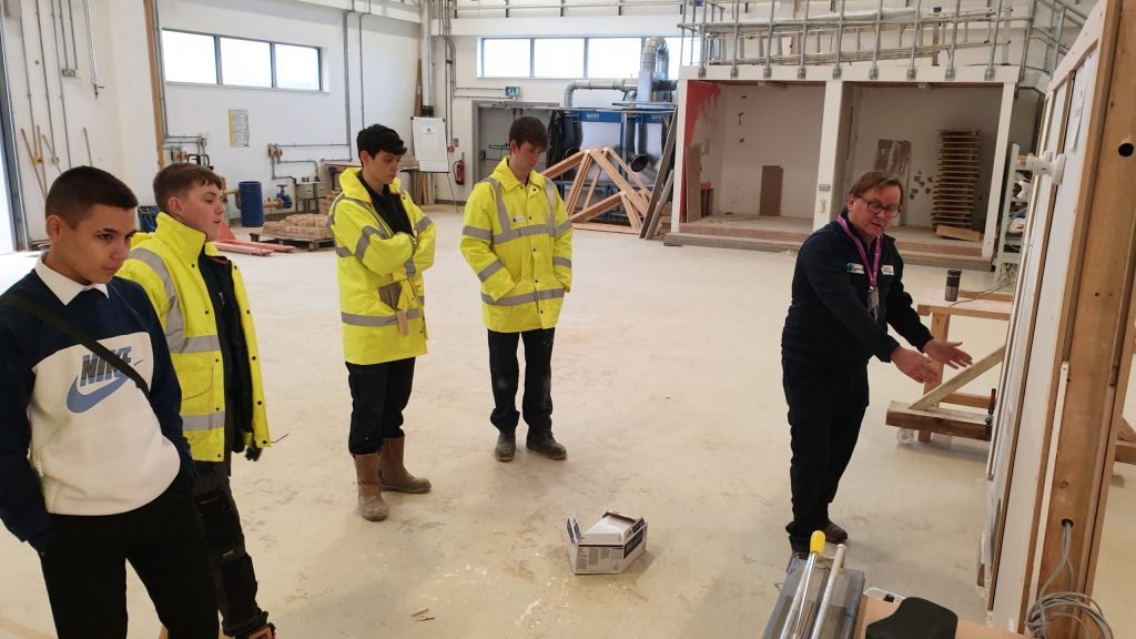 Construction students wearing high-vis standing up