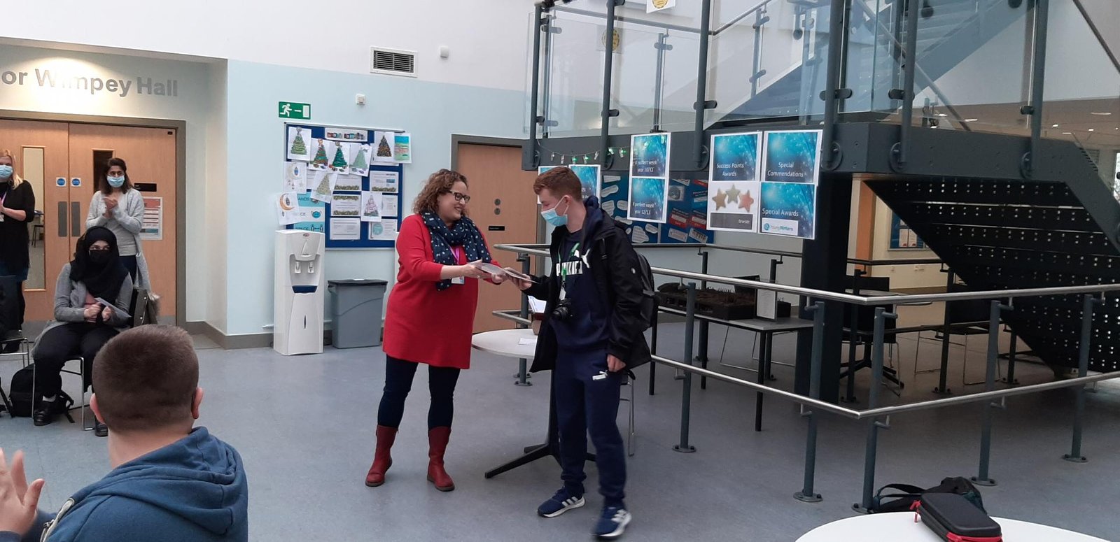 Male student receiving award